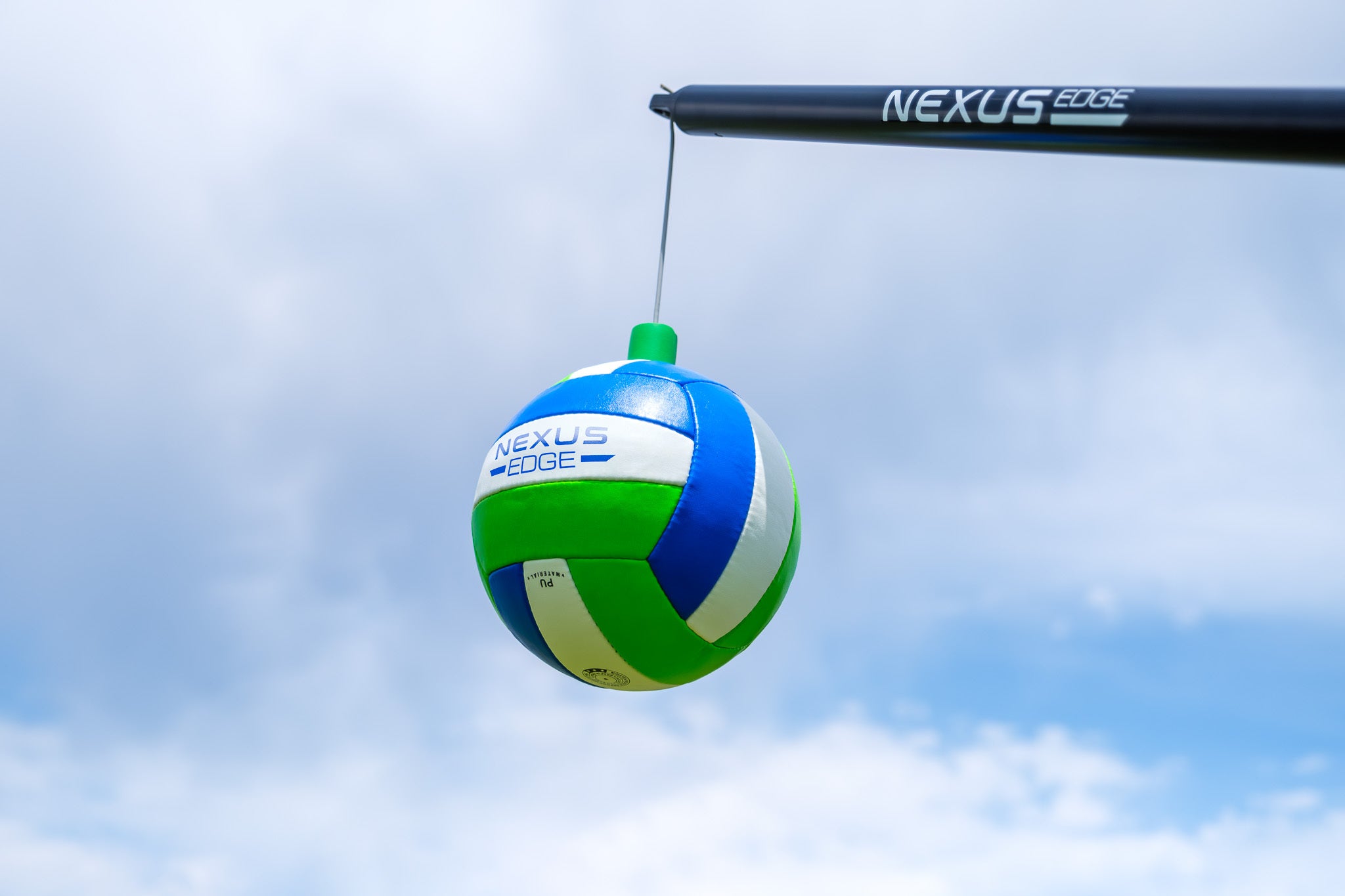 A Nexus Edge volleyball is suspended in the air using the Nexus Edge