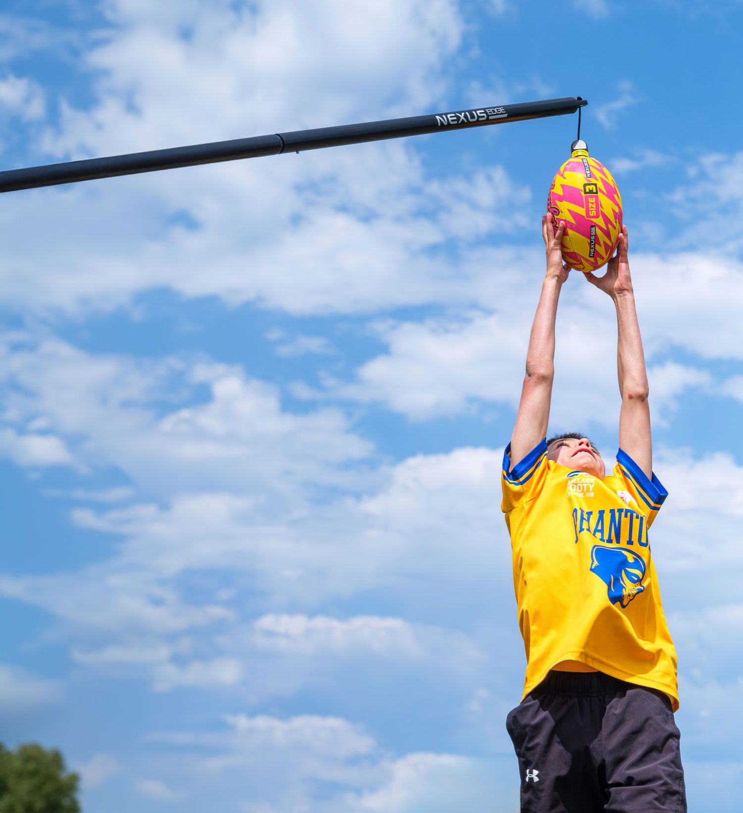 A child marks a football midair using the Nexus Edge