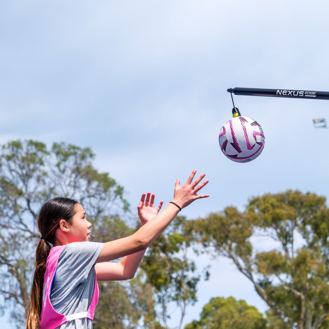 A child practises their netball skills using the Nexus Edge