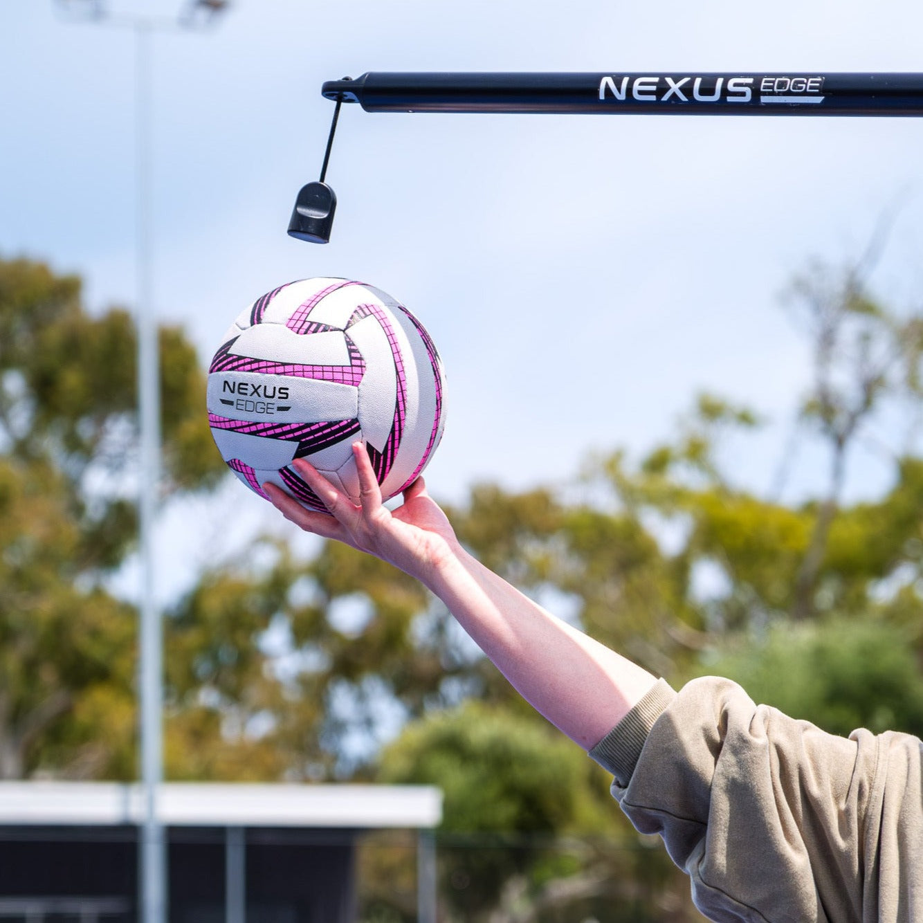 A person hold a Nexus Edge netball to set up for netball skill practice