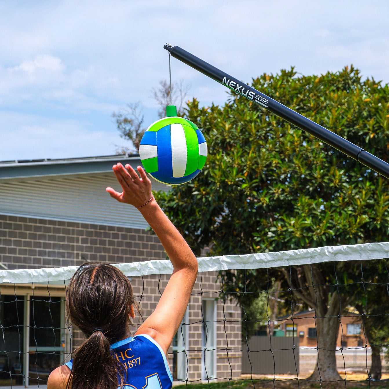 A person performs a volleyball spike using the Nexus Edge