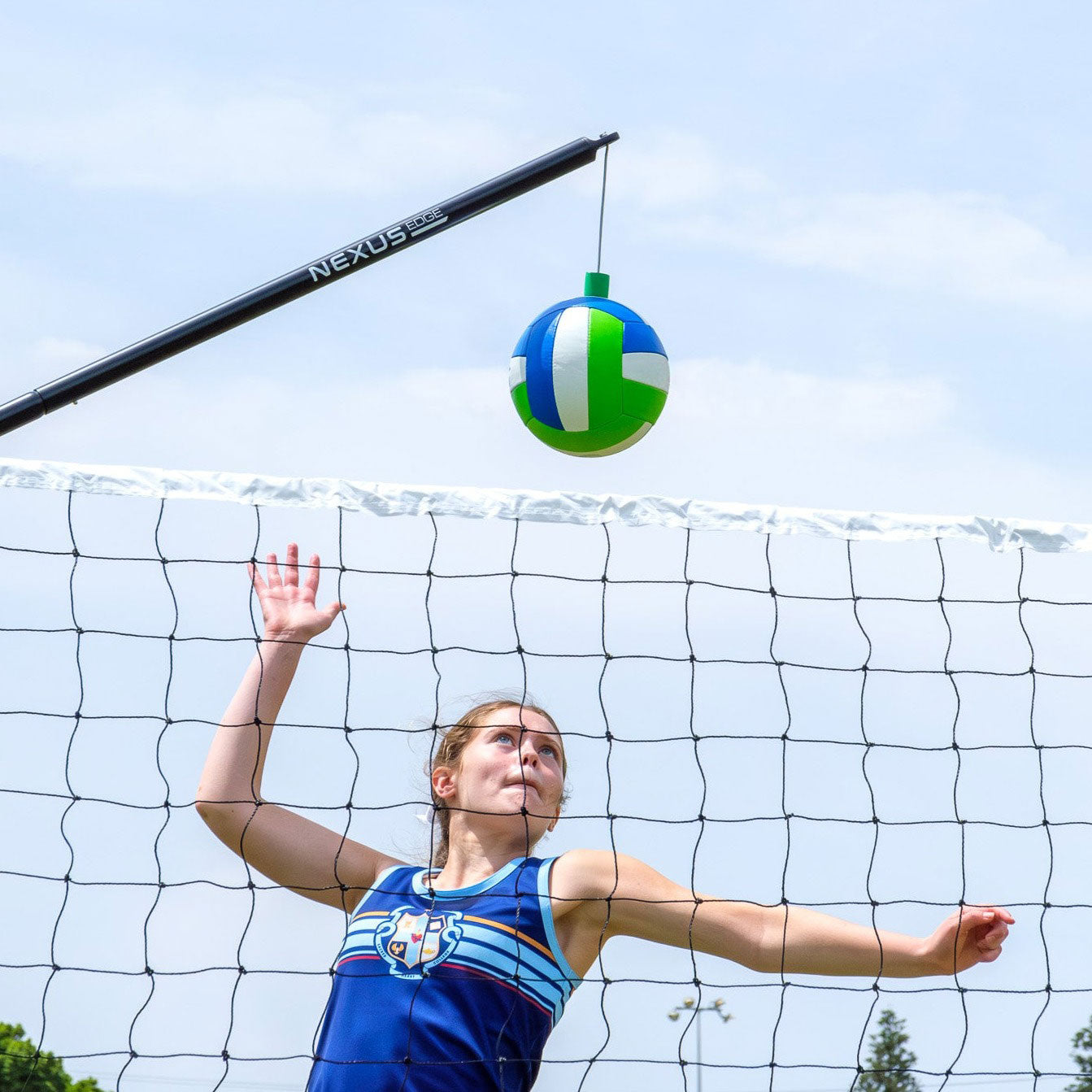 A person performs a volleyball spike using the Nexus Edge